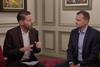 Gabriel Mair sits with Christopher Ludwig on a red sofa for an interview
