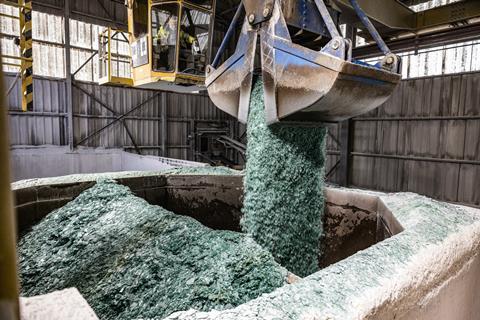 Glass being deposited for recycling, as part of Audi's glass recycling loop