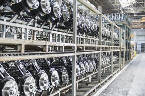 Large number of axles on shelving unit in car plant