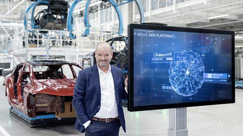 Jörg Burzer, Member of the Board of Management of Mercedes-Benz Group AG, responsible for Production & Supply Chain Management shows the MO360 platform on a screen at a Mercedes passenger car plant